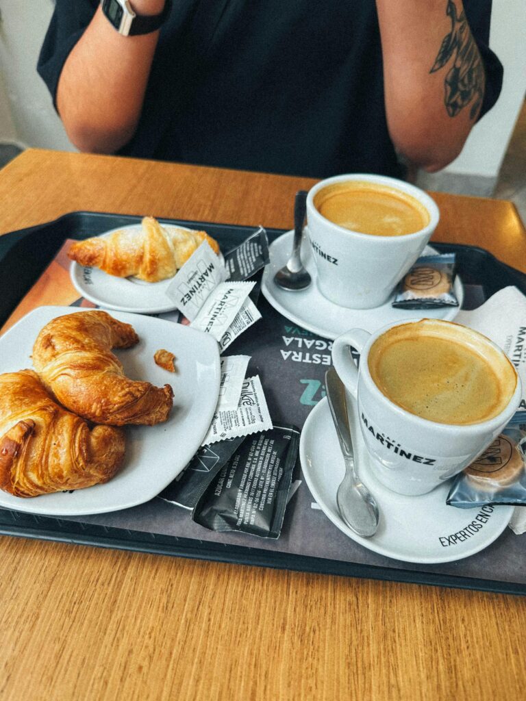 Enjoy a delightful breakfast featuring cappuccino and croissants at a café in Buenos Aires.