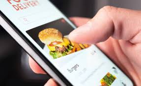 “Customer ordering a burger through a mobile app using food delivery services in Hyderabad”