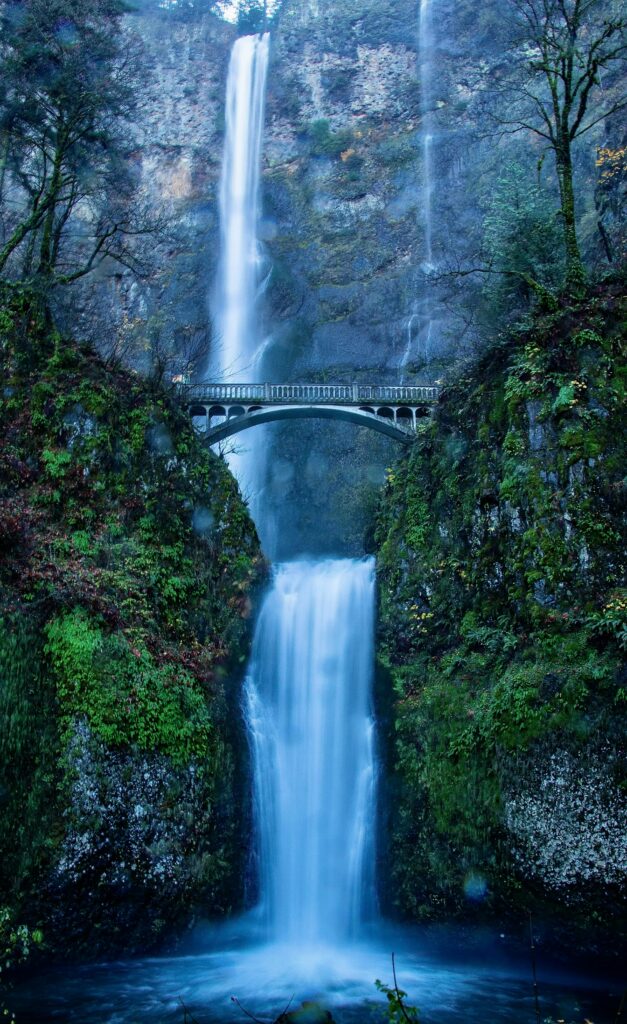 Breathtaking view of Multnomah Falls with iconic bridge in lush Oregon landscape.